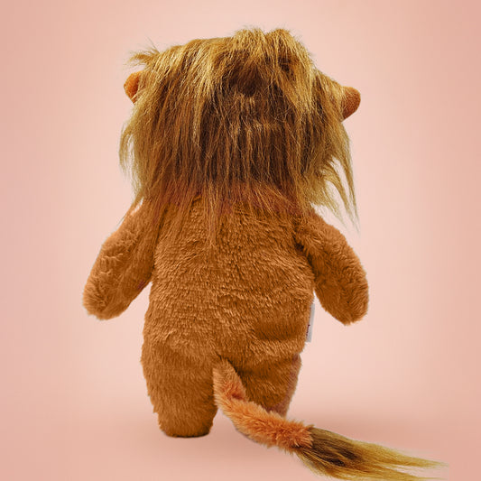Plush lion toy on a pink background