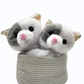 Two plush cat toys in a woven basket on a white background