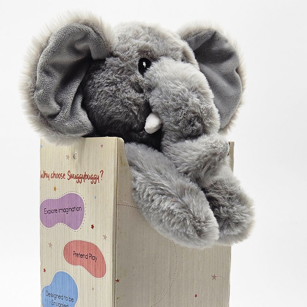 Gray plush elephant toy in a wooden box with text on a white background