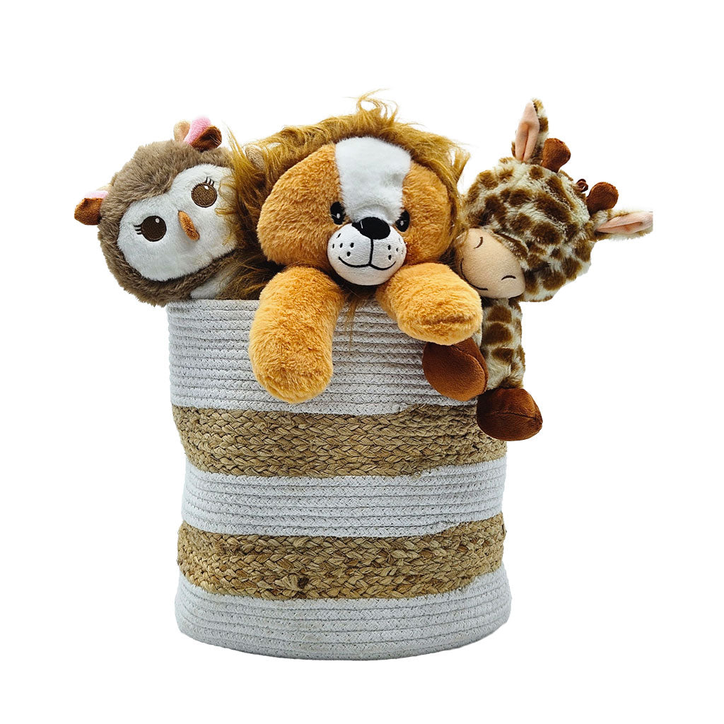 Round cotton and jute woven storage basket holding three plush toys (lion, owl, and giraffe), used for organizing toys in a kids’ room.