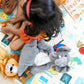 Child playing with stuffed animals on a colorful educational mat