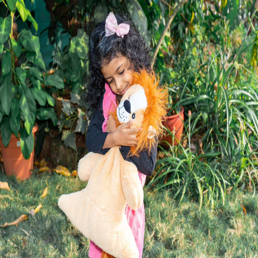 kid hugging a snuggybuggy lion plushie