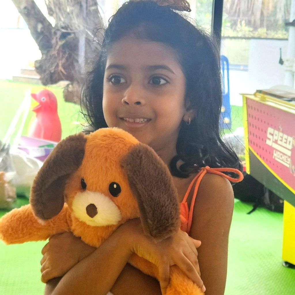 Kid hugging a doggy soft toy