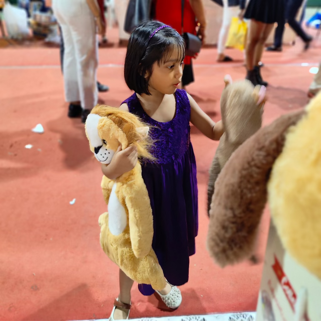 Kid playing with two plushies. 